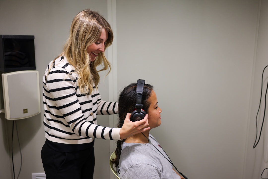 A hearing screening is being set up in the audiology booth.